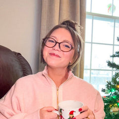 A woman wearing Mona oval cocoa brown glasses